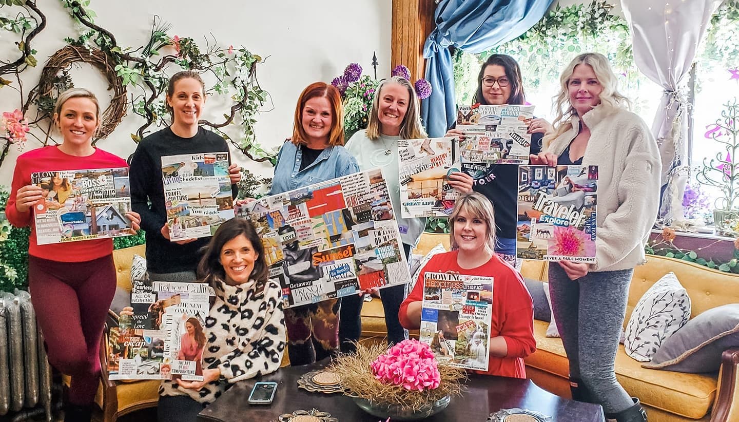 A group of women holding their finished vision boards